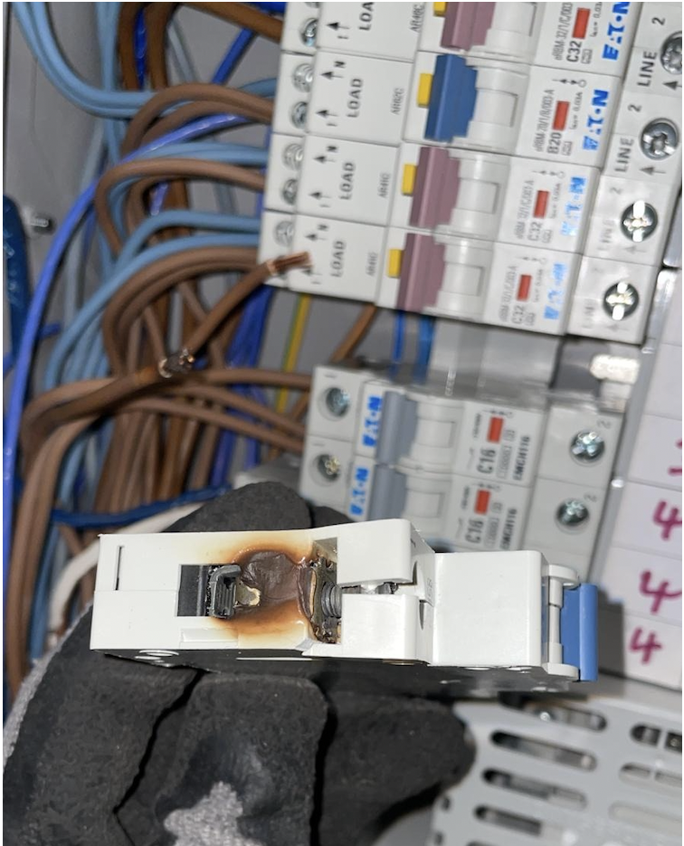 Burned MCB discovered during an EICR inspection — a C1 defect requiring immediate remedial action