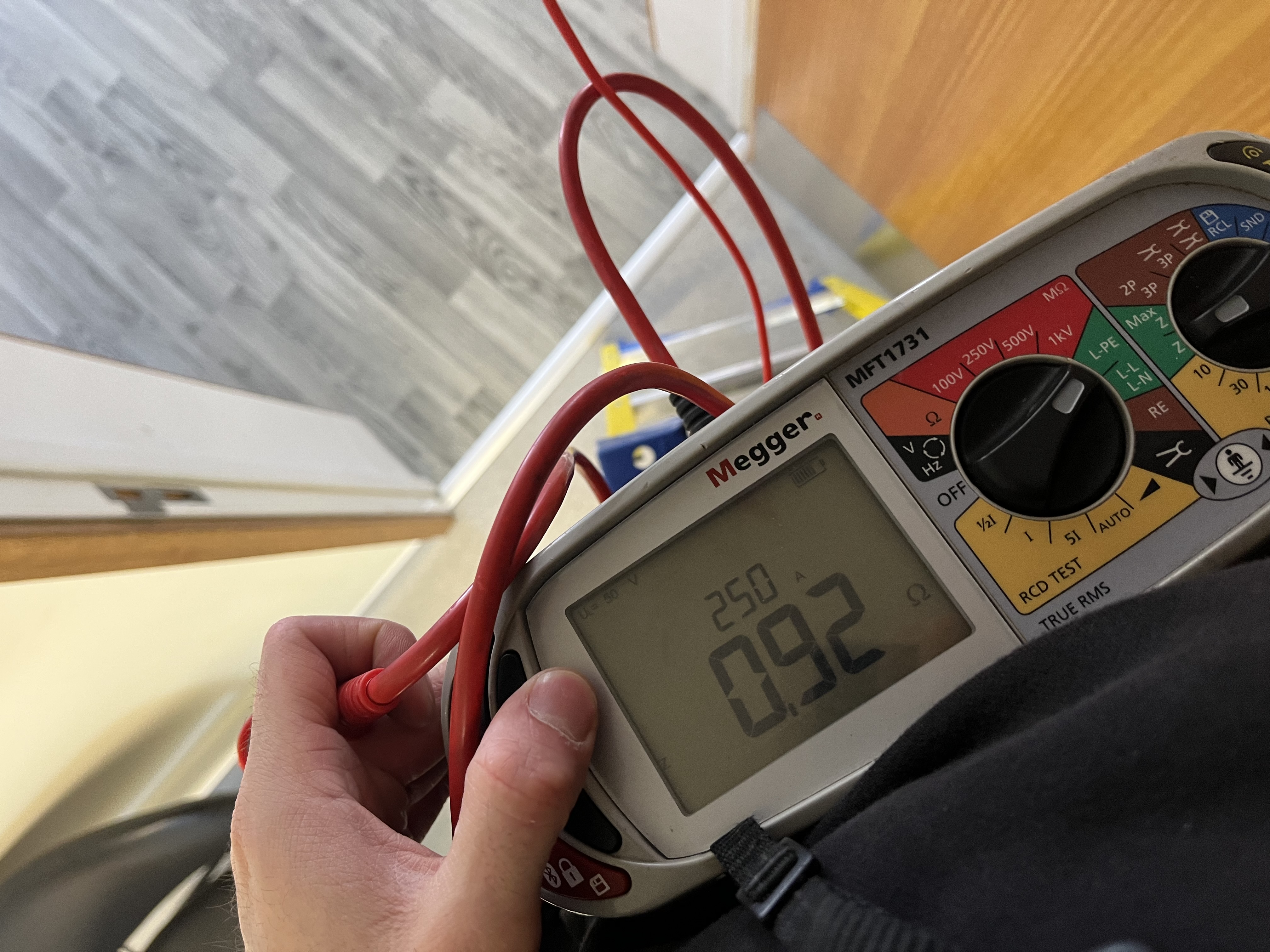 ProConform engineer using a Megger MFT1731 multifunction tester during an EICR