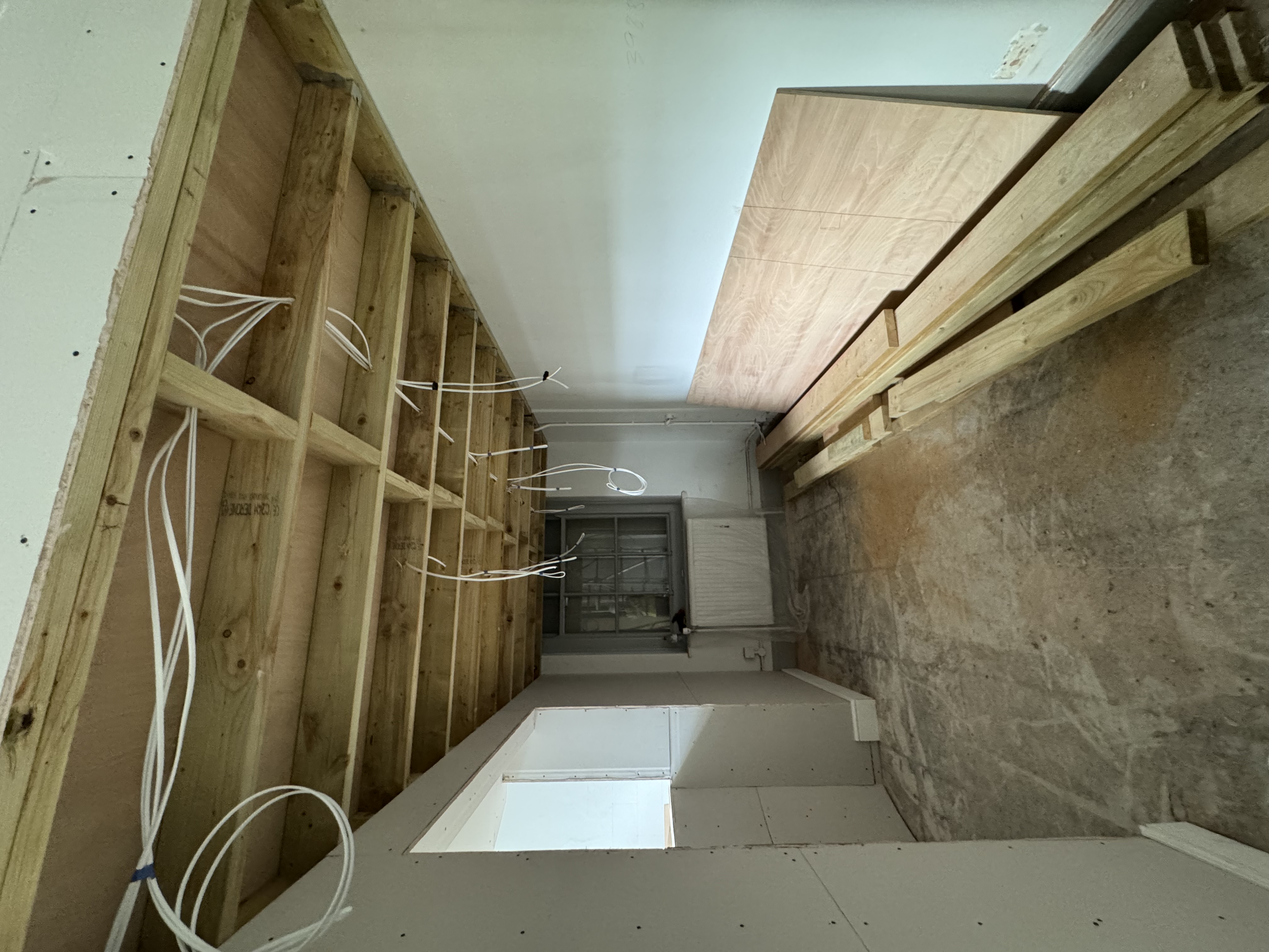 First-fix electrical cables dropped through a new timber ceiling frame during a domestic rewire